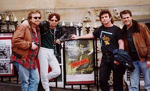 Bobby Mack and band pose before a promotional poster for The Bristish Blues festival